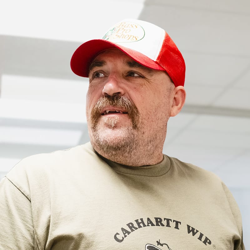 Man wearing Bass Pro Shops cap and Carhartt WIP t-shirt