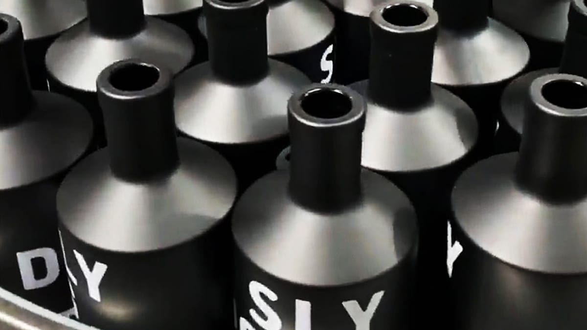 Multiple matte black spray cans with white lettering