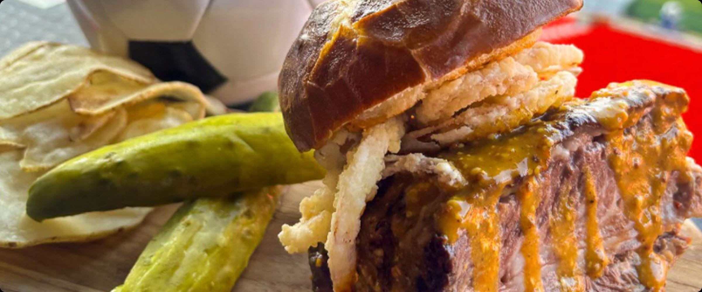 Loaded beef burger with sauce, pickles, and crisps